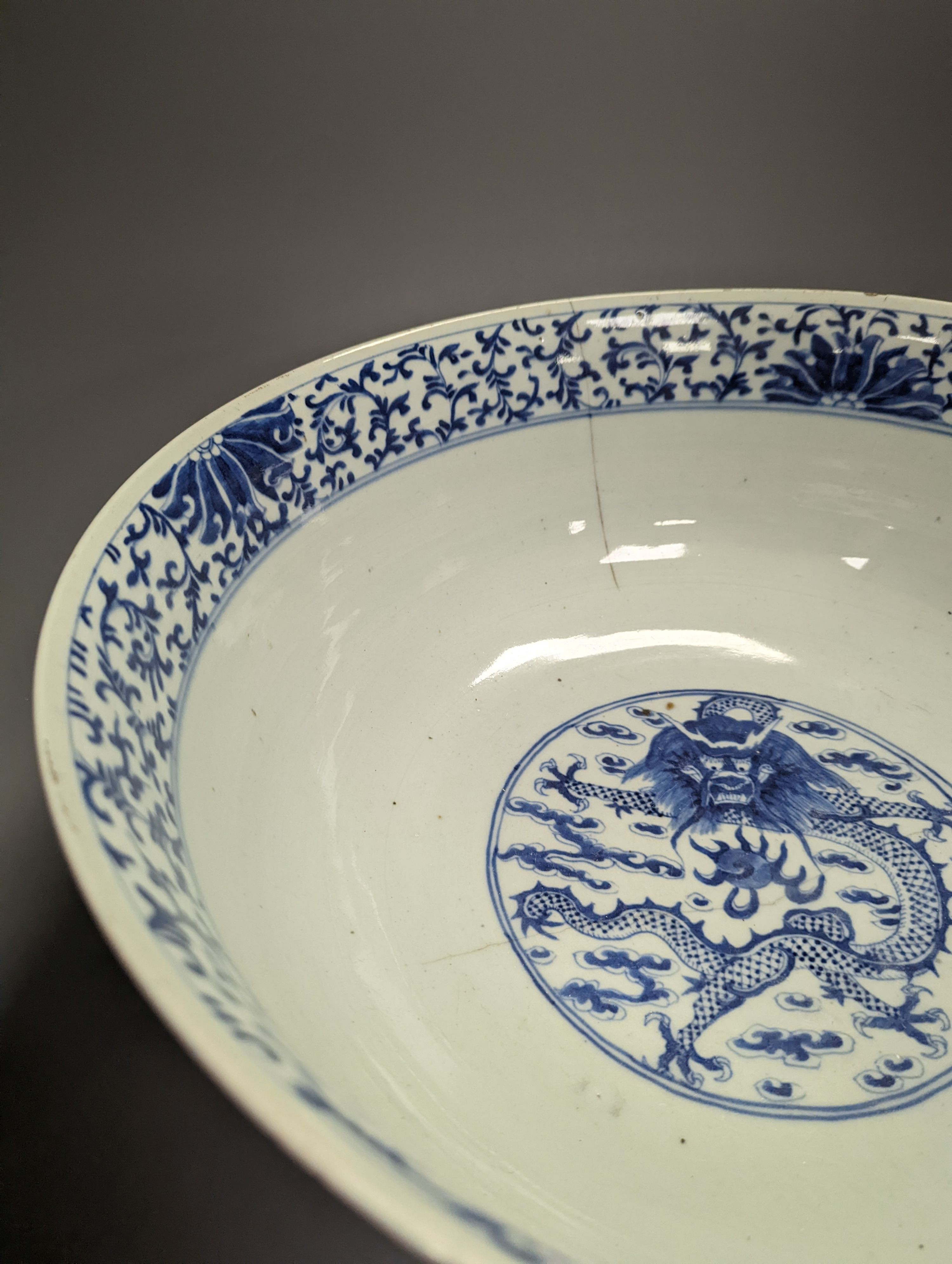 A large 19th century Chinese blue and white ‘dragon’ bowl (a.f.) 41cm